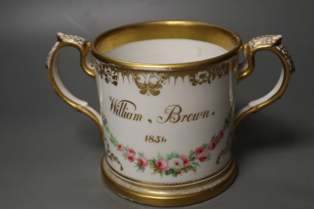 An English porcelain two handled mug lavishly painted with flowers, inscribed verso William Brown 1854, 14cm